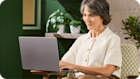 Image of a person sitting and looking at a laptop. The visual suggests how users can learn about 11 of the best web analytics tools.