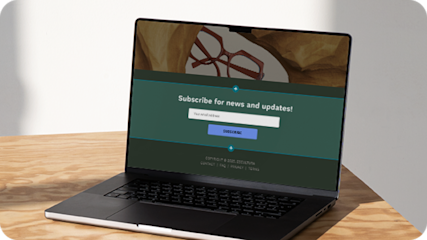 Laptop on a wooden table showing a popup form on an e-commerce website, offering visitors an opportunity to subscribe to the brand’s newsletter by providing their email address. 
